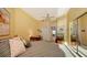 Well-lit bedroom with a writing desk, striped bedding, and balcony access at 340 S Palm Ave # 152, Sarasota, FL 34236