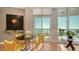 Bright dining area with waterfront views from the sliding glass door to the private balcony at 340 S Palm Ave # 152, Sarasota, FL 34236