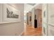 Bright hallway features modern art, light wood floors, and leads to a living area with stunning views at 340 S Palm Ave # 152, Sarasota, FL 34236