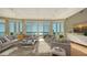 Bright living room with floor-to-ceiling windows offering stunning water views and comfortable seating at 340 S Palm Ave # 152, Sarasota, FL 34236