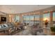 Elegant living room featuring floor-to-ceiling windows with stunning water views and a plush seating arrangement at 340 S Palm Ave # 152, Sarasota, FL 34236