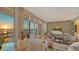 Elegant living room with stunning sunset views over the water, stylish decor, and a cozy seating area at 340 S Palm Ave # 152, Sarasota, FL 34236