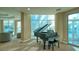 Bright living room featuring a grand piano, large windows with views, and comfortable seating area at 340 S Palm Ave # 152, Sarasota, FL 34236