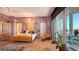 Expansive bedroom featuring a four-poster bed, sitting area, and balcony access with city views at 340 S Palm Ave # 152, Sarasota, FL 34236