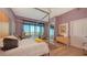 Spacious primary bedroom with a four-poster bed and balcony showcasing beautiful city views at 340 S Palm Ave # 152, Sarasota, FL 34236