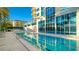 Relaxing swimming pool with crystal clear water and plenty of lounge chairs with a partial building view at 340 S Palm Ave # 152, Sarasota, FL 34236