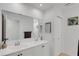 A bright bathroom featuring a double vanity and large mirror at 3417 Tallywood Ln, Sarasota, FL 34237