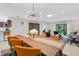 Open-concept dining room with modern lighting and furniture flowing into the living space at 3417 Tallywood Ln, Sarasota, FL 34237