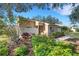 Charming single-story home featuring a mix of light and dark landscaping and a stone wall facade accent at 3417 Tallywood Ln, Sarasota, FL 34237
