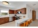 Kitchen featuring wood cabinets, stainless steel appliances, and a breakfast bar at 3417 Tallywood Ln, Sarasota, FL 34237