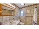 Tiled bathroom featuring framed mirror, medicine cabinet, and a tiled shower at 3716 Camino Real, Sarasota, FL 34239