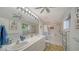 Bright bathroom featuring double sinks, large mirror and walk-in shower at 3716 Camino Real, Sarasota, FL 34239