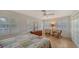 Comfortable bedroom features tiled floors, shuttered windows, ceiling fan, and neutral decor at 3716 Camino Real, Sarasota, FL 34239