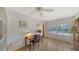 Bright bedroom featuring a ceiling fan, neutral colors, and tiled floors at 3716 Camino Real, Sarasota, FL 34239