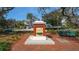 Community water fountain with brick paved area and benches at 3716 Camino Real, Sarasota, FL 34239