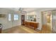 Warm and inviting entryway with tiled floors, wood furniture, a large mirror, and a partial view of the dining area at 3716 Camino Real, Sarasota, FL 34239