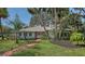 Charming one story home with brick path, chimney, neutral colors, and mature landscaping at 3716 Camino Real, Sarasota, FL 34239