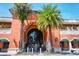 Morton's Market entrance, framed by palm trees, offers a unique shopping experience at 3716 Camino Real, Sarasota, FL 34239