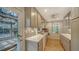Kitchen featuring wood floors, a mosaic tile backsplash, light countertops, and stainless sink at 3716 Camino Real, Sarasota, FL 34239