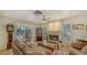 Living room area with tile floors, fireplace, built in bookshelf, and lots of light at 3716 Camino Real, Sarasota, FL 34239