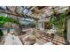 Charming outdoor space with a pergola, comfortable seating, and access to the pool area, perfect for entertaining at 3716 Camino Real, Sarasota, FL 34239