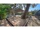 Charming outdoor space with a pergola, comfortable seating, and access to the pool area, perfect for entertaining at 3716 Camino Real, Sarasota, FL 34239