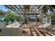 Relaxing outdoor seating area with a pergola, stylish wicker furniture, and a lovely ambiance for enjoying the outdoors at 3716 Camino Real, Sarasota, FL 34239