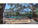 Enclosed swimming pool with screened in enclosure and brick pool deck at 3716 Camino Real, Sarasota, FL 34239