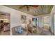 Sunroom features wicker seating, tile floors, and access to the living room at 3716 Camino Real, Sarasota, FL 34239