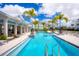 Stunning community pool offering a refreshing oasis with palm trees and stylish lounge areas at 405 Gowdy Rd, Sarasota, FL 34237