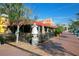 Outdoor restaurant with sidewalk seating, mature trees, and an inviting atmosphere on a sunny day at 405 Gowdy Rd, Sarasota, FL 34237