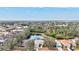 An aerial view of a community with large trees and a tranquil lake at 406 116Th E St, Bradenton, FL 34212