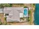 A top-down aerial shot revealing a backyard with a pool, a pond, and a well-maintained roof at 406 116Th E St, Bradenton, FL 34212