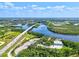 Aerial view of a scenic highway bridge traversing a tranquil river with lush greenery at 406 116Th E St, Bradenton, FL 34212
