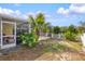 Backyard with a screened-in porch, a small garden, and a white picket fence at 406 116Th E St, Bradenton, FL 34212