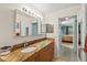 Bathroom featuring a granite countertop, vanity with drawers, and a view of bedroom suite at 406 116Th E St, Bradenton, FL 34212