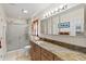 Modern bathroom with a granite countertop, vanity with multiple drawers, shower with glass doors, and tile floors at 406 116Th E St, Bradenton, FL 34212