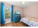 Cozy bedroom with a desk, wood floors, colorful bedding, and a bright window at 406 116Th E St, Bradenton, FL 34212