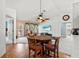 Cozy dining area featuring wood floors, decorative lighting, and a view into the living room at 406 116Th E St, Bradenton, FL 34212