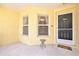 A cozy front porch with neutral colors and a view of the yard and landscaping at 406 116Th E St, Bradenton, FL 34212