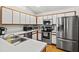 Well-lit kitchen featuring stainless steel appliances, white cabinets, and ample counter space at 406 116Th E St, Bradenton, FL 34212