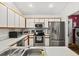 Modern kitchen featuring stainless steel appliances, white cabinets, and a double basin sink at 406 116Th E St, Bradenton, FL 34212