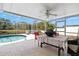 Screened-in lanai features an in-ground pool, seating area, and lake views at 406 116Th E St, Bradenton, FL 34212