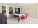 Covered patio area featuring dining table and chairs with a television at 406 116Th E St, Bradenton, FL 34212