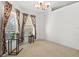 Bright room featuring neutral carpet, bay windows with colorful curtains, and modern lighting fixture at 406 116Th E St, Bradenton, FL 34212