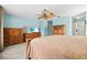 Spacious carpeted main bedroom with ceiling fan, walk-in closet, ensuite bath, and light blue walls at 406 116Th E St, Bradenton, FL 34212