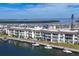 Scenic aerial view of waterfront condos with boat docks, lush landscaping, and calming water views at 4390 Exeter Dr # I305, Longboat Key, FL 34228