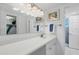 Bright bathroom featuring a clean white vanity and a well-lit mirror, complemented by a charming piece of wall art at 4390 Exeter Dr # I305, Longboat Key, FL 34228