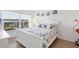 Bright bedroom with seashell bedding, white furniture and windows overlooking the city at 4390 Exeter Dr # I305, Longboat Key, FL 34228