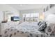 Airy bedroom with white furniture, seashell bedding and a TV for relaxing at 4390 Exeter Dr # I305, Longboat Key, FL 34228